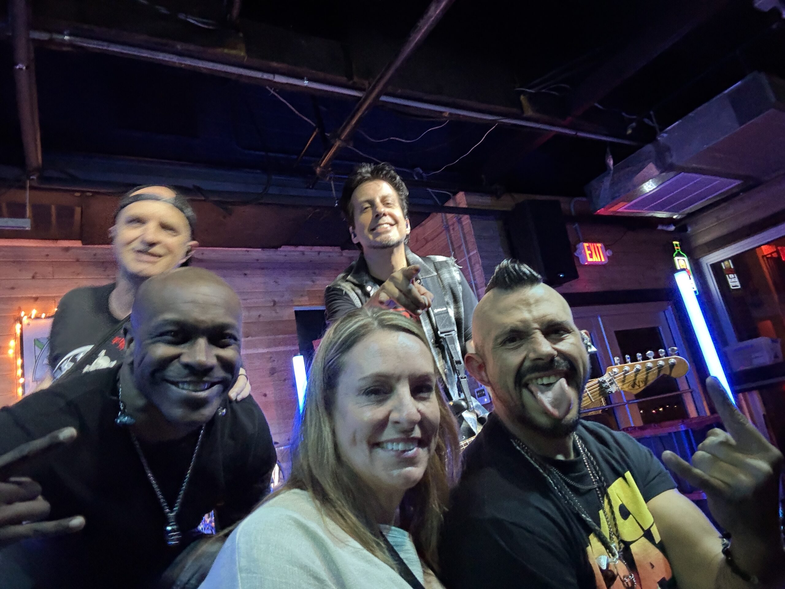 Friends enjoying live music at a St. Pete Beach bar near Isla del Sol Florida