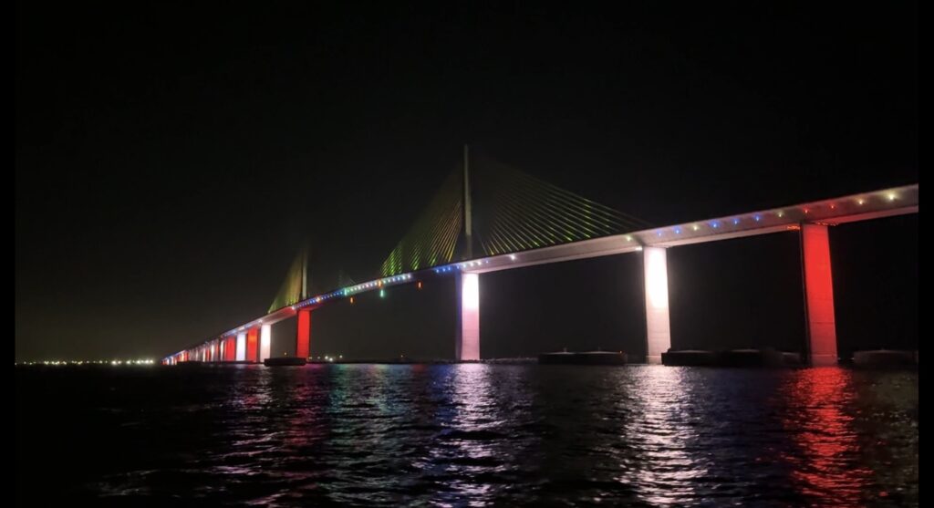 Sunshine Skyway Bridge illuminated at night reflecting on Tampa Bay waters
