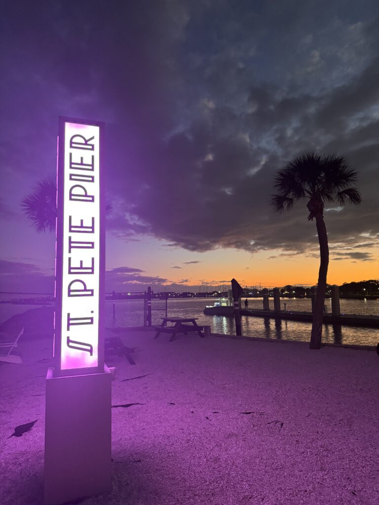 St. Pete Pier at night illuminated with purple and blue lights in downtown St. Petersburg Florida