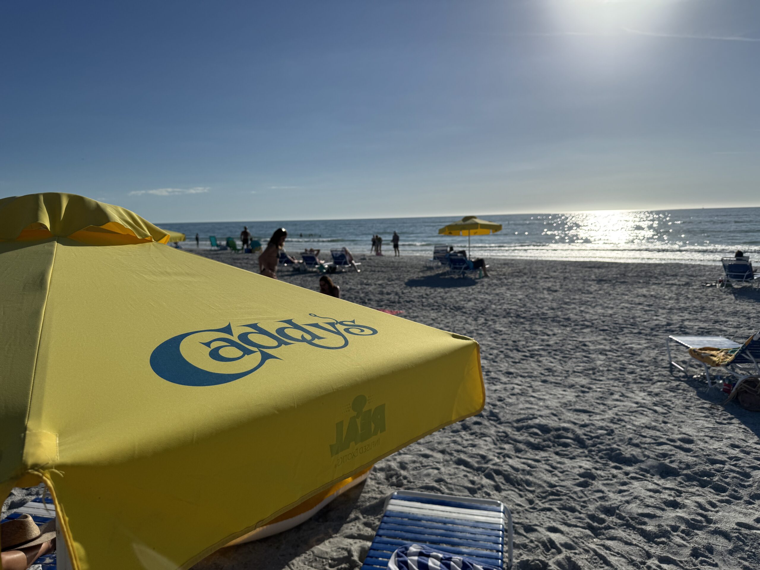 Beach day on St. Pete Beach with yellow umbrella and refreshing drinks near Bahia 155
